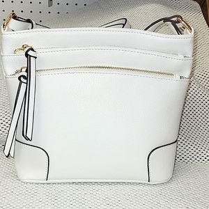 White crossbody purse with lots of pockets.